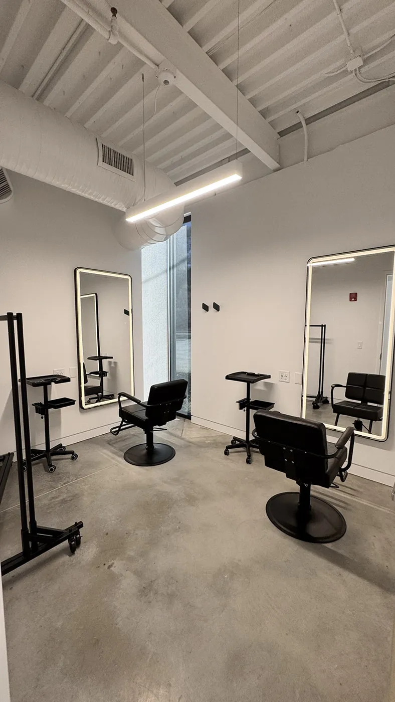 Hair & Makeup suite with lit mirrors and salon chairs